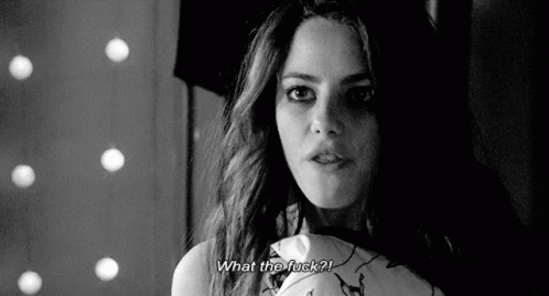 A Black And White Photo Of A Woman Holding A Pillow And Asking What The Fuck ? GIF