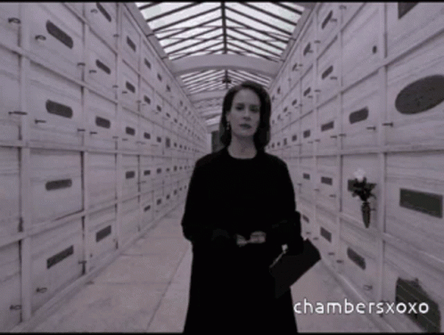 A Black And White Photo Of A Woman In A Cemetery With Chambersxoxo Written On The Bottom Right GIF