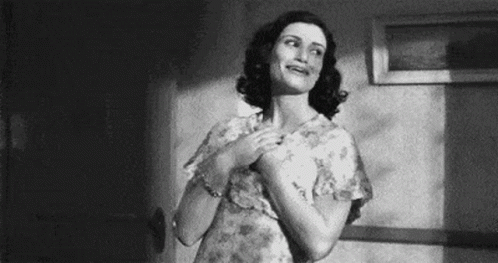 A Black And White Photo Of A Woman In A Floral Dress . GIF