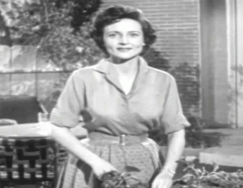 A Black And White Photo Of A Woman In A Polka Dot Dress GIF