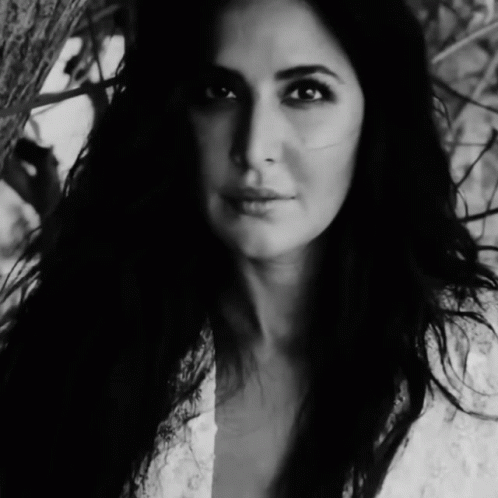 A Black And White Photo Of A Woman In A White Dress GIF