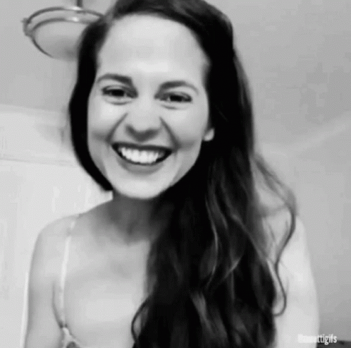 A Black And White Photo Of A Woman Laughing . GIF