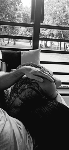 A Black And White Photo Of A Woman Laying On A Man 'S Lap GIF