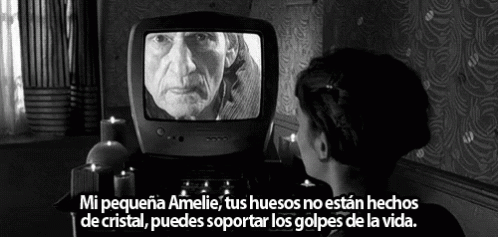 A Black And White Photo Of A Woman Looking At An Old Man On A Tv GIF