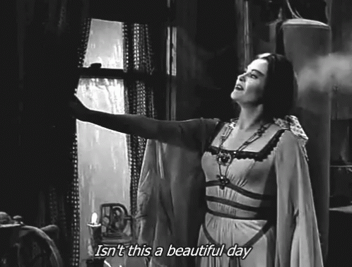 A Black And White Photo Of A Woman Looking Out A Window With The Caption Isn 'T This A Beautiful Day . GIF