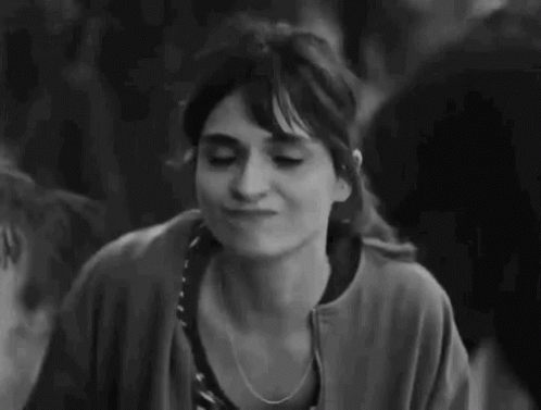 A Black And White Photo Of A Woman Making A Funny Face And Giving A Thumbs Up . GIF