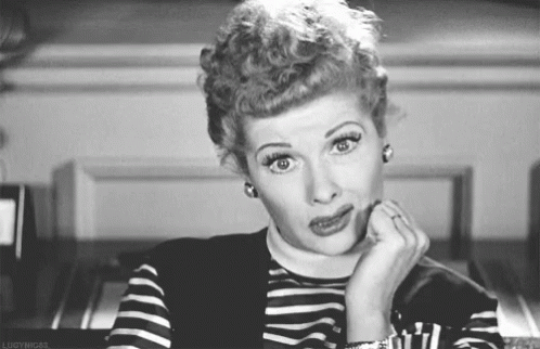 A Black And White Photo Of A Woman Making A Funny Face With Her Hand On Her Chin . GIF