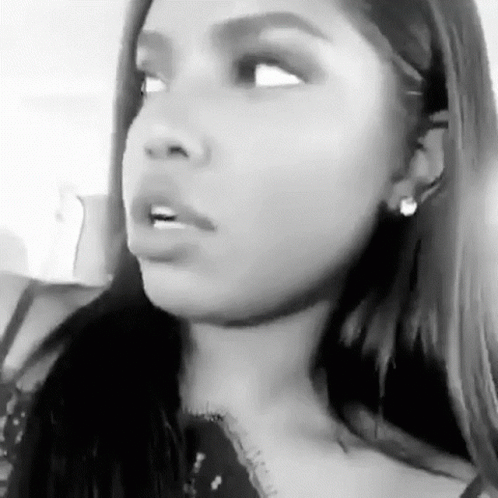 A Black And White Photo Of A Woman Making A Funny Face With Her Mouth Open . GIF