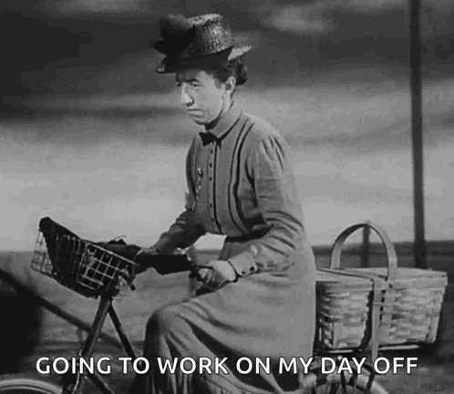 A Black And White Photo Of A Woman Riding A Bicycle With The Words `` Going To Work On My Day Off '' Below Her . GIF