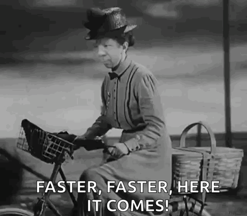 A Black And White Photo Of A Woman Riding A Bike With The Words `` Faster , Faster , Here It Comes '' GIF