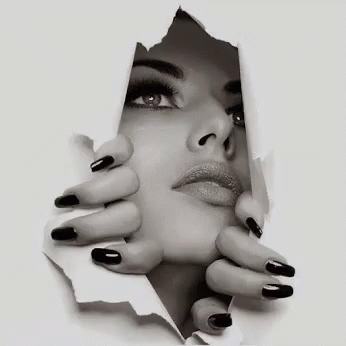 A Black And White Photo Of A Woman 'S Face Behind A Piece Of Paper . GIF