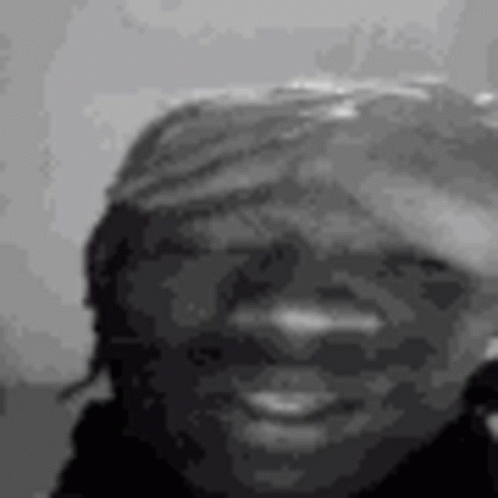 A Black And White Photo Of A Woman 'S Face Smiling . GIF
