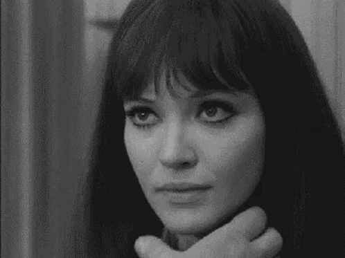 A Black And White Photo Of A Woman 'S Face With A Hand On Her Neck . GIF