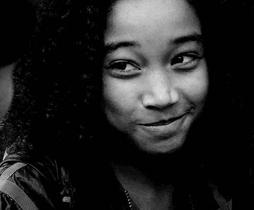 A Black And White Photo Of A Woman 'S Face With A Smile On Her Face . GIF