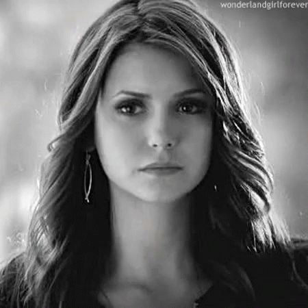 A Black And White Photo Of A Woman 'S Face With Long Hair . GIF