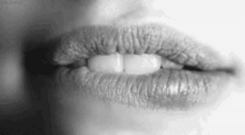 A Black And White Photo Of A Woman 'S Lips With Lipstick On Them . GIF