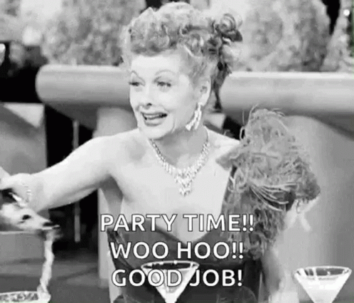 A Black And White Photo Of A Woman Sitting At A Table With A Martini Glass And A Bottle Of Champagne . GIF