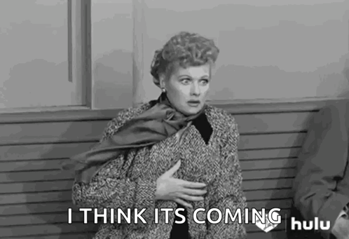 A Black And White Photo Of A Woman Sitting On A Bench . GIF