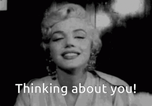 A Black And White Photo Of A Woman Smiling With The Words `` Thinking About You '' Written Below Her . GIF