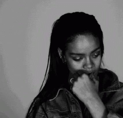 A Black And White Photo Of A Woman Smoking A Cigarette . GIF