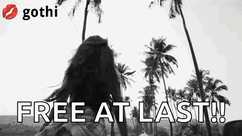 A Black And White Photo Of A Woman Standing In Front Of Palm Trees And The Words `` Free At Last ! '' GIF