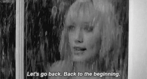 A Black And White Photo Of A Woman Standing In The Rain And Talking . GIF