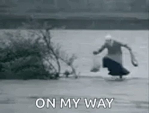 A Black And White Photo Of A Woman Walking On The Ice With The Words `` On My Way '' . GIF