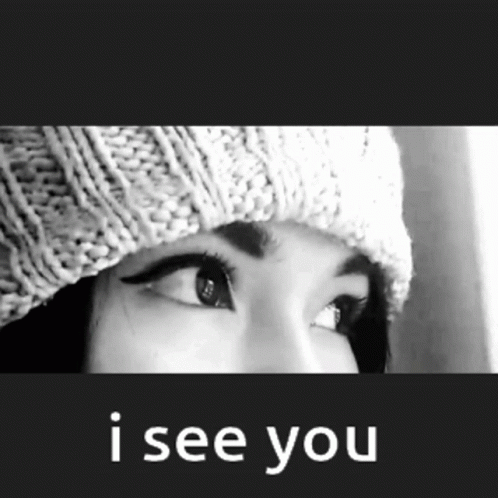 A Black And White Photo Of A Woman Wearing A Knitted Hat And The Words I See You Below Her GIF
