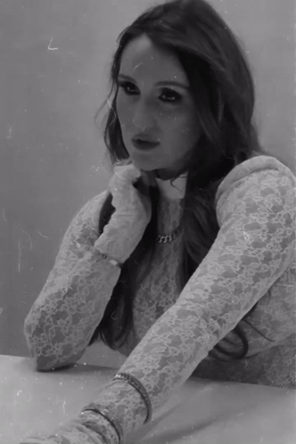 A Black And White Photo Of A Woman Wearing A Lace Top And Gloves GIF