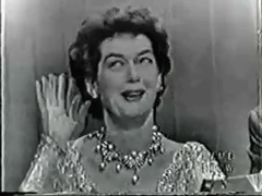 A Black And White Photo Of A Woman Wearing A Necklace Waving Her Hand . GIF
