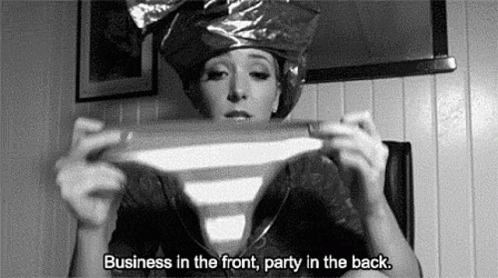 A Black And White Photo Of A Woman Wearing A Plastic Bag On Her Head Holding A Striped Shirt . GIF