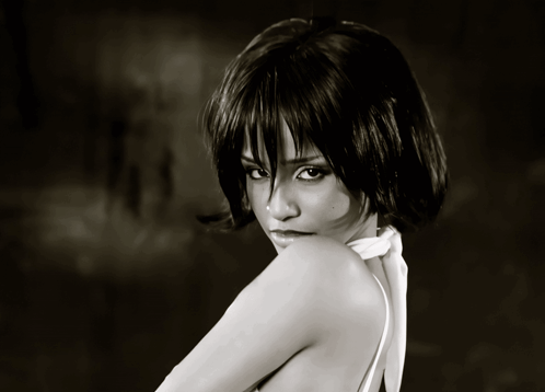 A Black And White Photo Of A Woman Wearing A White Top GIF
