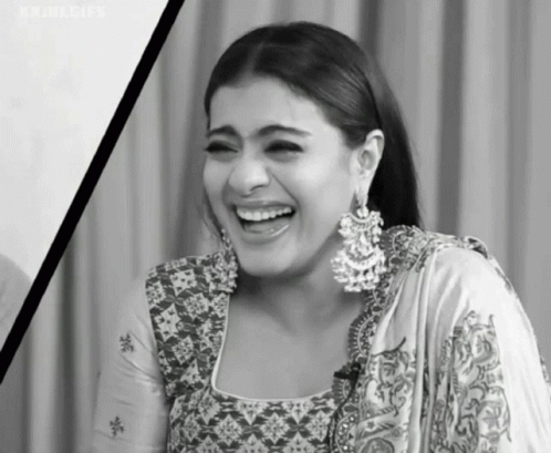 A Black And White Photo Of A Woman Wearing Earrings Laughing . GIF