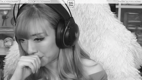 A Black And White Photo Of A Woman Wearing Headphones With The Words Stella Chuu On The Bottom Right GIF