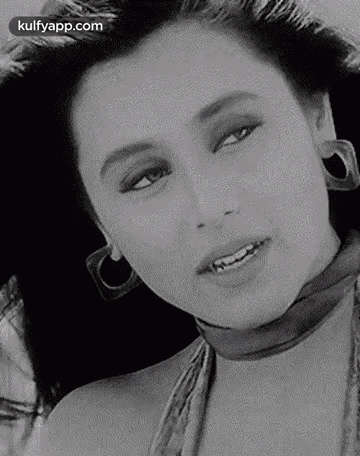 A Black And White Photo Of A Woman Wearing Hoop Earrings And A Choker . GIF