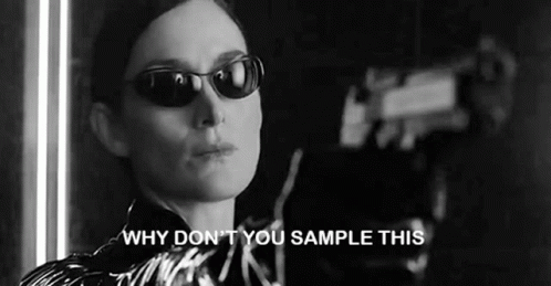 A Black And White Photo Of A Woman Wearing Sunglasses And Saying `` Why Don T You Sample This '' . GIF
