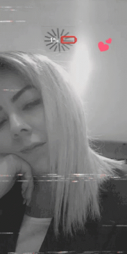 A Black And White Photo Of A Woman With A Clock Behind Her That Says 1% On It GIF