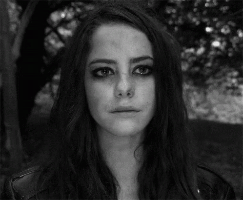 A Black And White Photo Of A Woman With A Crying Face . GIF