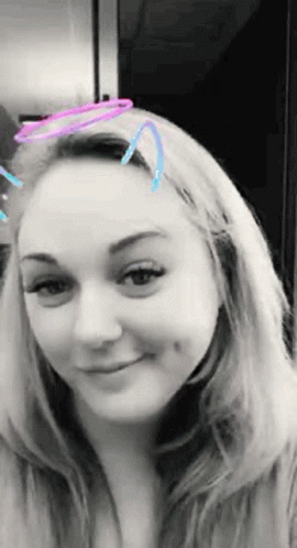 A Black And White Photo Of A Woman With A Filter On Her Face GIF