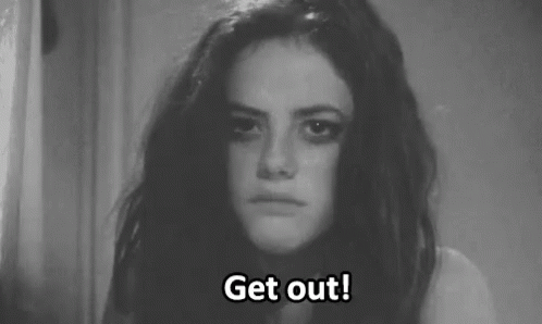 A Black And White Photo Of A Woman With A Sad Look On Her Face . GIF