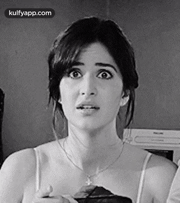 A Black And White Photo Of A Woman With A Surprised Look On Her Face And A Necklace . GIF