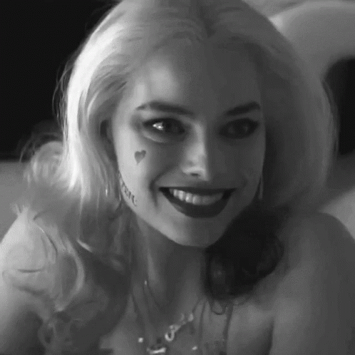 A Black And White Photo Of A Woman With A Tattoo On Her Face . GIF