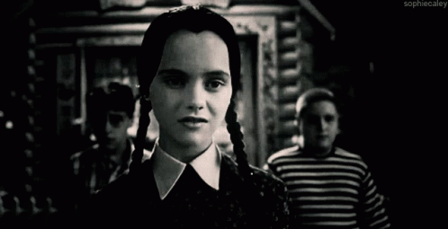 A Black And White Photo Of A Woman With Braids Making A Funny Face . GIF