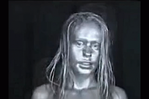A Black And White Photo Of A Woman With Dreadlocks And A Dirty Face . GIF