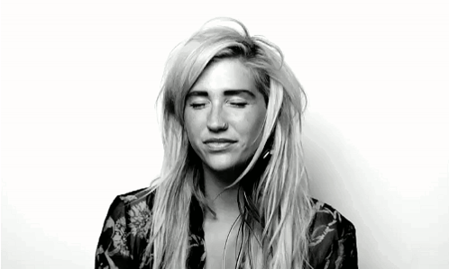 A Black And White Photo Of A Woman With Her Eyes Closed And A Nose Piercing . GIF