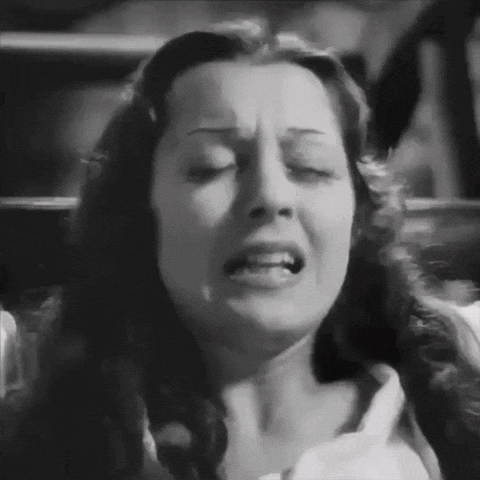A Black And White Photo Of A Woman With Her Eyes Closed And Her Mouth Open . GIF