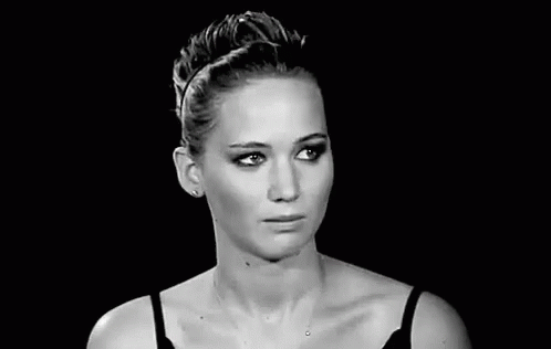 a black and white photo of a woman with her eyes closed .