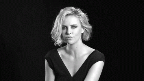 A Black And White Photo Of A Woman With Her Hand On Her Face GIF