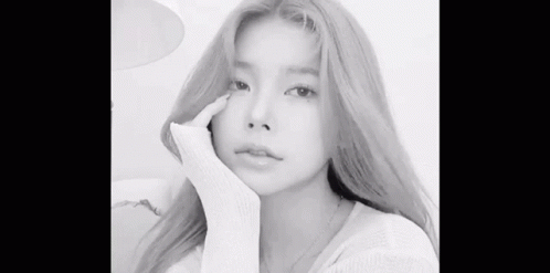 A Black And White Photo Of A Woman With Long Blonde Hair Taking A Selfie . GIF