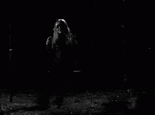 A Black And White Photo Of A Woman With Long Hair GIF